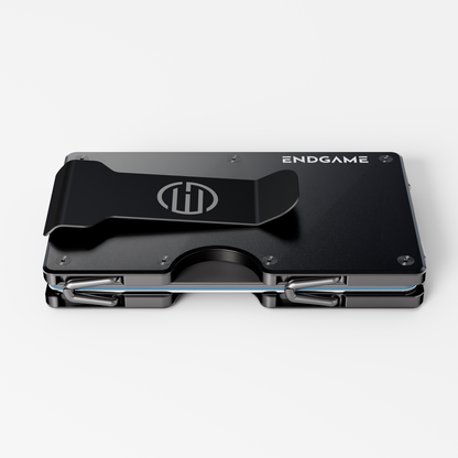 Back of an Endgame Carry aluminum wallet in Nero Abisso black, showing the stainless steel money clip and cards held between the plates