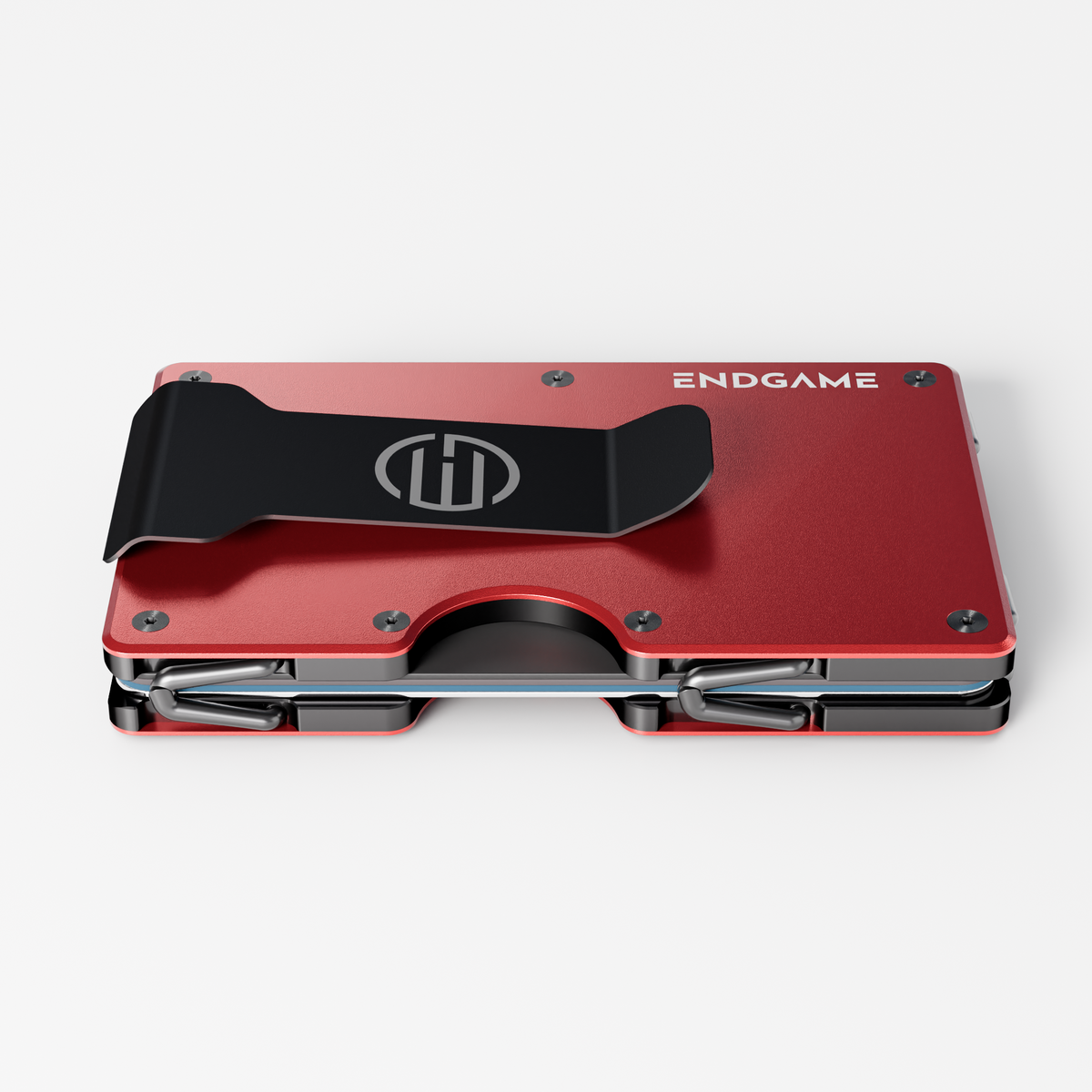 Back of an Endgame Carry aluminum wallet in Rosso Apice red, showing the stainless steel money clip and cards held between the plates