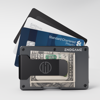 Endgame Carry aluminum wallet in Grigio Ferro grey with folded cash in the money clip and cards fanned out behind it