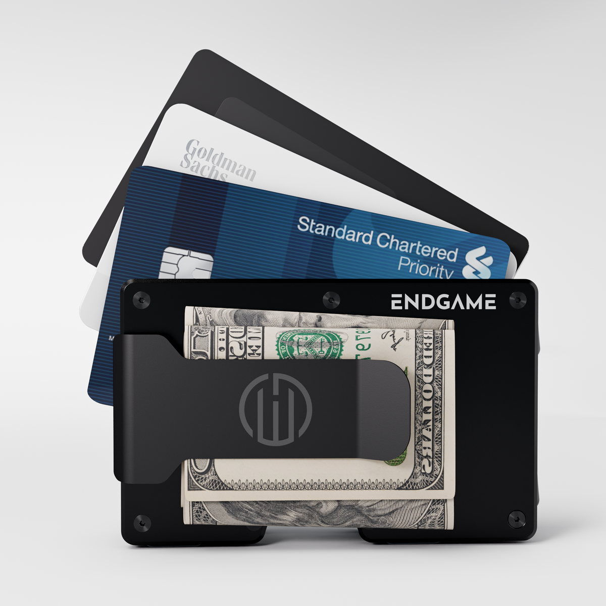 Endgame Carry aluminum wallet in Nero Abisso black with folded cash in the money clip and cards fanned out behind it
