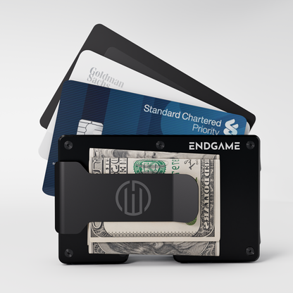 Endgame Carry aluminum wallet in Nero Abisso black with folded cash in the money clip and cards fanned out behind it