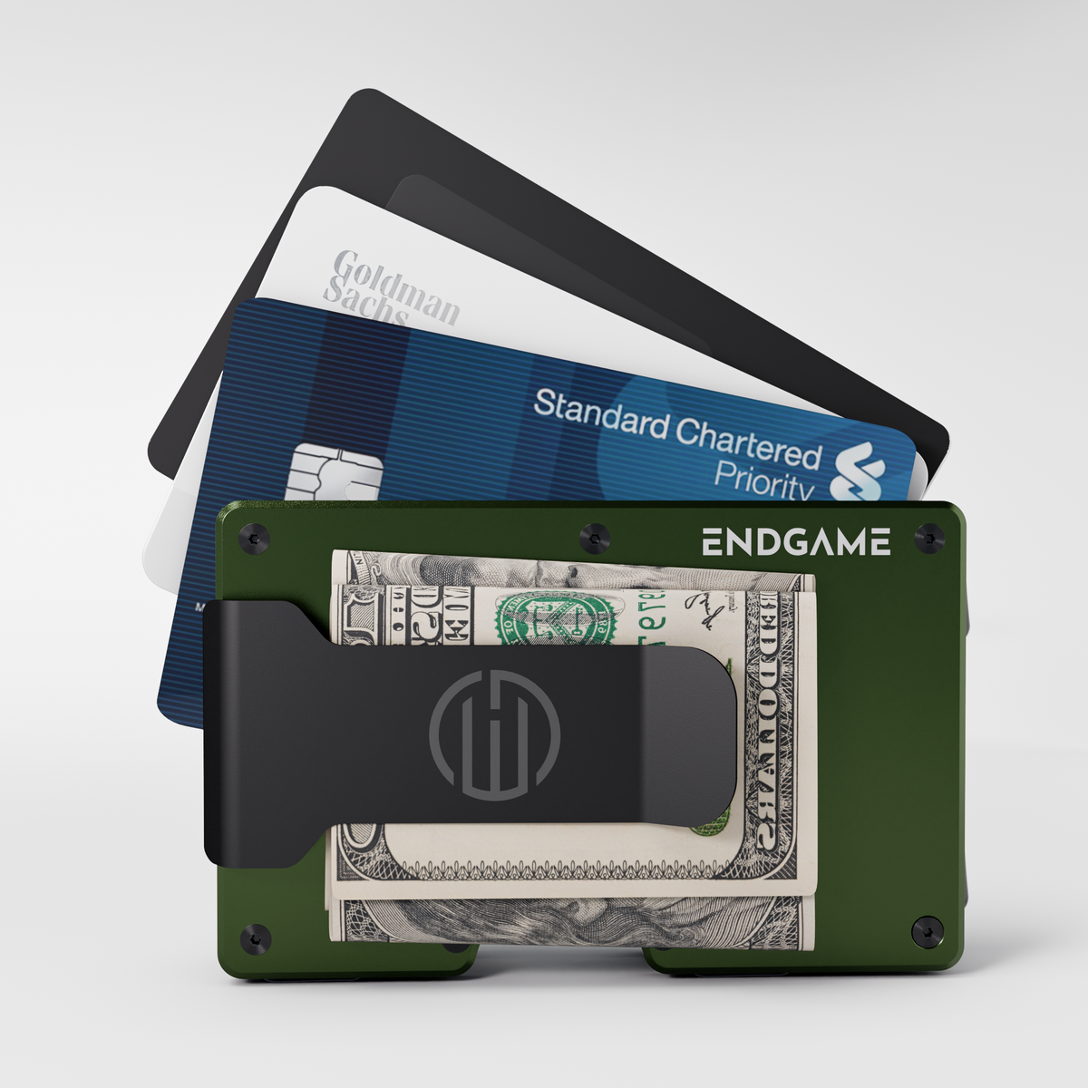 Endgame Carry aluminum wallet in Verde Selva green with folded cash in the money clip and cards fanned out behind it