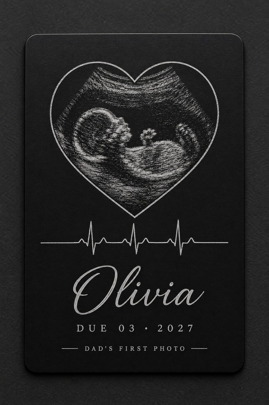 Heart: an ultrasound scan inside a heart with the name Olivia, engraved on a black aluminum wallet card